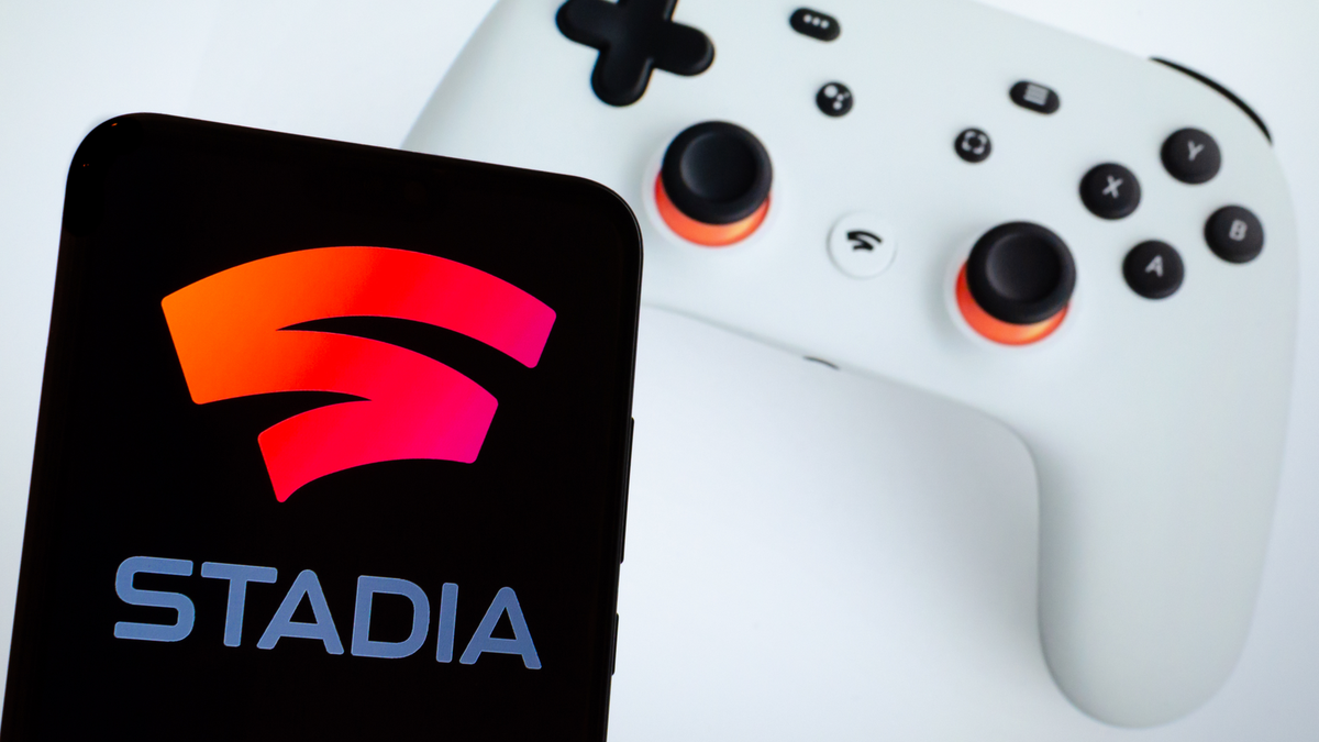 Smartphone avec logo Stadia à côté du contrôleur de jeu Stadia