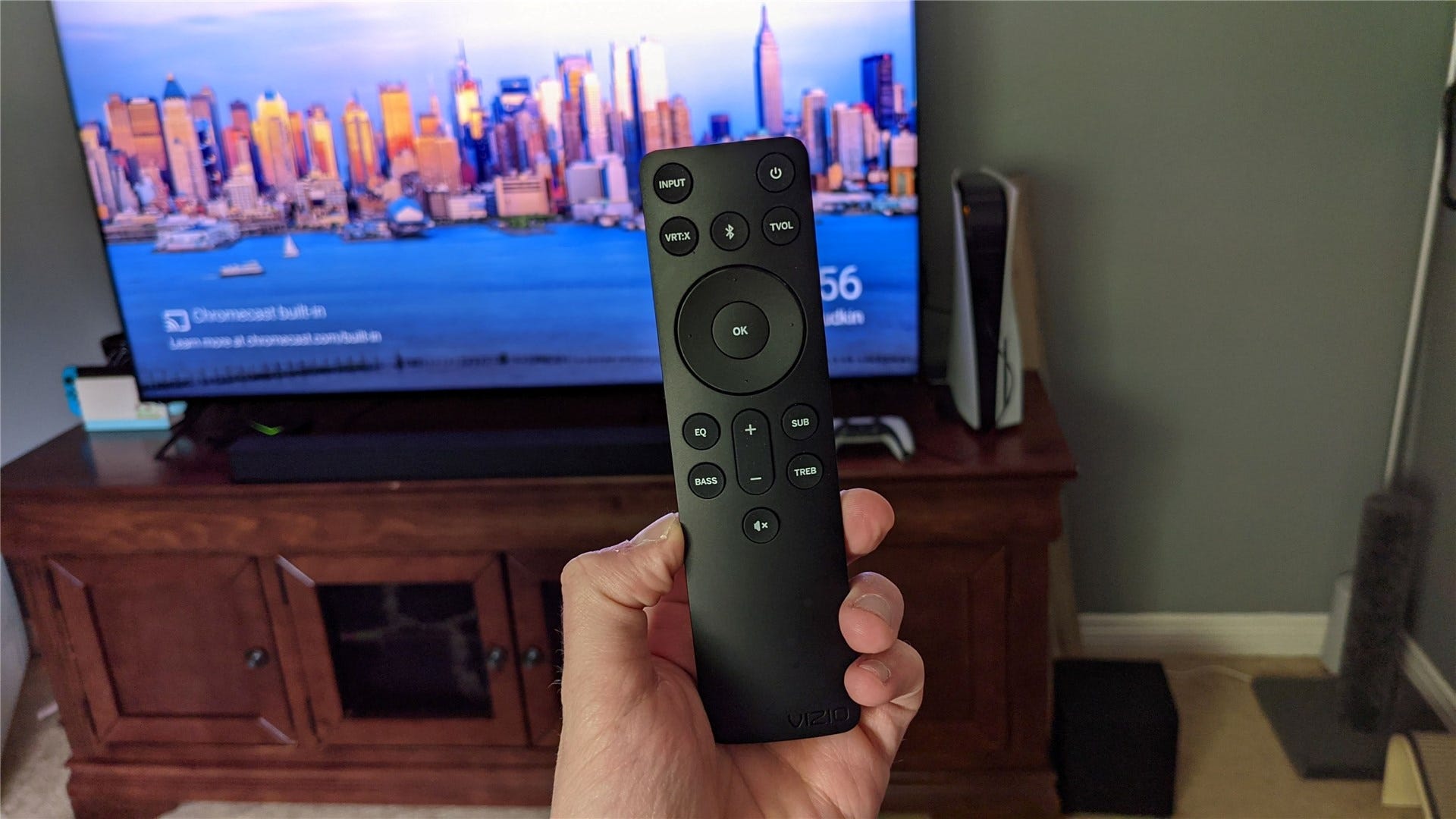Il telecomando, la TV sullo sfondo