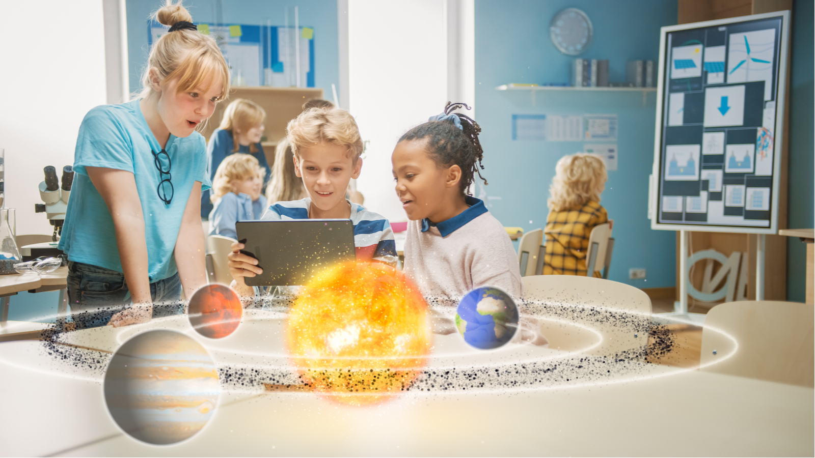 Drie verschillende schoolkinderen in de wetenschapsklas die een digitale tabletcomputer met augmented reality-software gebruiken om over planeten te leren