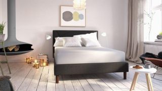 Zinus Green Tea memory foam mattress review: mattress shown on a bed in the centre of a well-lit bedroom with a log burner and coffee table