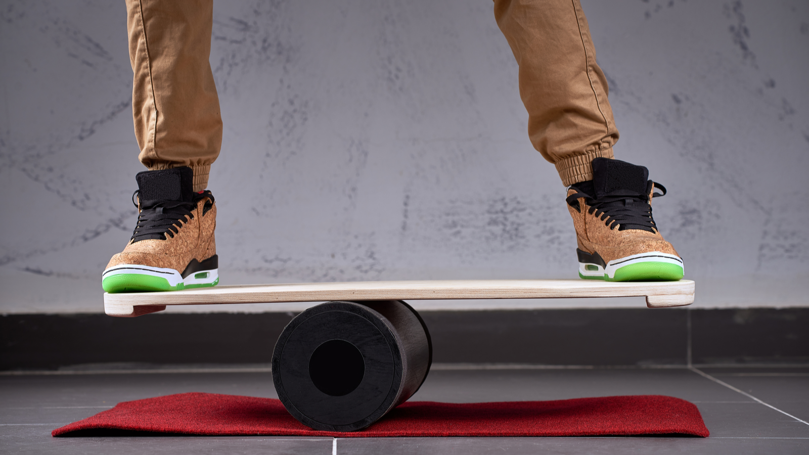 Sàn gỗ hình bầu dục dùng cho ván thăng bằng, con lăn nhựa đặc dùng cho ván thăng bằng, người mang giày trượt băng nghệ thuật đứng và giữ thăng bằng trên boong