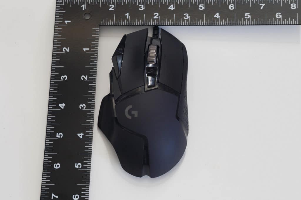 Logitech G502 HERO High Performance Gaming Mouse próximo à régua mostrando o tamanho